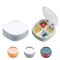 Square pill organizer with four compartments.