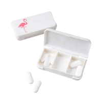 White pill organizer with flamingo design.
