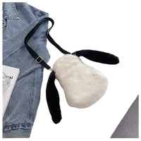 White furry bunny purse with black ears and a black strap.