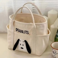 Cream-colored canvas tote bag with Snoopy design.