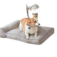 Gray dog bed with a corgi.