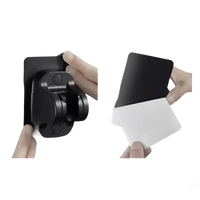 Black shower head holder with adhesive backing.