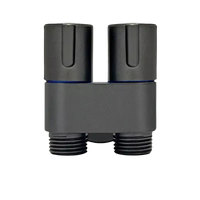 Black shower valve with two knobs and threaded outlets.