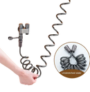 Coiled gray bidet hose with faucet.