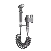 Gray bidet sprayer with coiled hose.