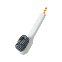 White cleaning brush with gray bristles.