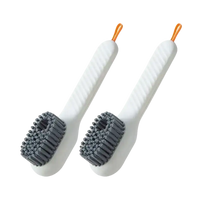 Two white cleaning brushes.