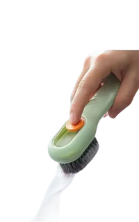 Green cleaning brush with orange button.