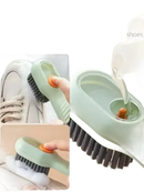 Green cleaning brush with soap dispenser.