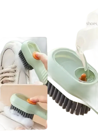 Green cleaning brush with soap dispenser.