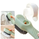 Green cleaning brush with soap dispenser.