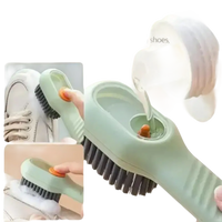 Green cleaning brush with soap dispenser.