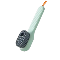 Light green cleaning brush with gray bristles.