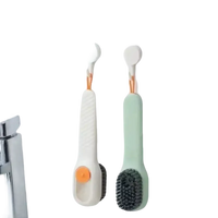 Two hanging cleaning brushes.