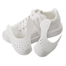 White shoe with toe box inserts.