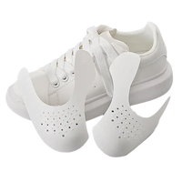 White shoe with toe box inserts.