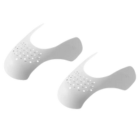 White perforated shoe shapers.