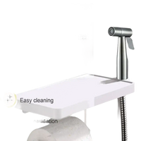 Stainless steel bidet sprayer with shelf.