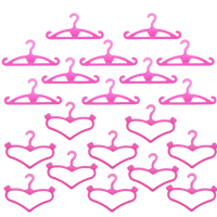 Pink plastic doll clothes hangers.