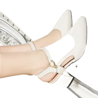 White leather pointed-toe heels.