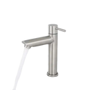 Brushed nickel bathroom faucet with running water.