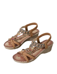 Tan wedge sandals with beaded embellishments.