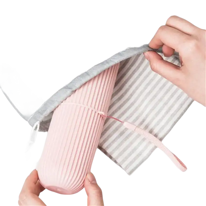 Pink ribbed water bottle in gray drawstring bag with Vertibrush Travel Kit and detangling hairbrush for trendy travel vibes