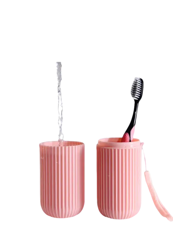Pink split toothbrush cup with toothbrush and water from Vertibrush Travel Kit, trendy vibe