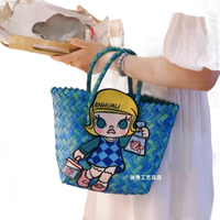 Blue woven tote bag with cartoon patch.