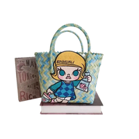 Woven handbag with cartoon girl patch.