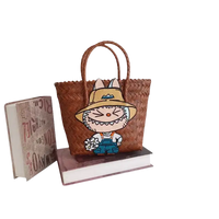 Brown woven tote bag with cartoon patch.