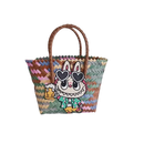 Woven tote bag with cartoon bunny patch.