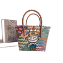 Colorful woven tote bag with cartoon patch.