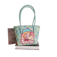 Woven blue and green tote bag with cartoon girl.