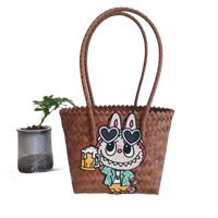 Brown woven tote bag with cartoon patch.