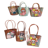 Handwoven straw bags with cartoon character embellishments.