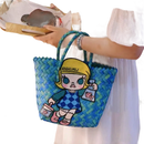 Blue woven tote bag with cartoon patch.