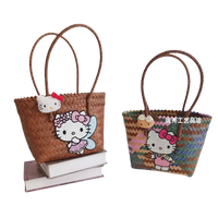 Woven straw tote bags with Hello Kitty embellishments.