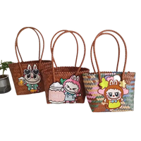 Three woven tote bags with cartoon character embellishments.