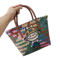 Woven tote bag with cartoon patch.