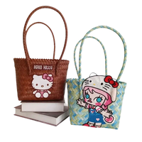 Two Hello Kitty woven handbags.