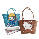 Two woven tote bags with cartoon appliqués.