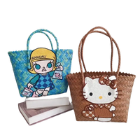 Two woven tote bags with cartoon appliqués.