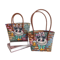 Two woven tote bags with cartoon bunny patches.