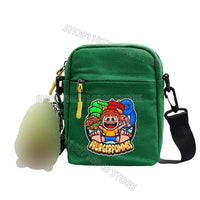Green canvas crossbody bag.
