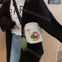 White crossbody bag with cartoon graphic.