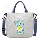 White tote bag with blue accents and a cartoon bear.
