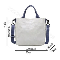 White tote bag with blue handles and strap.