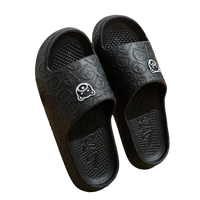 Black cartoon-patterned slide sandals.