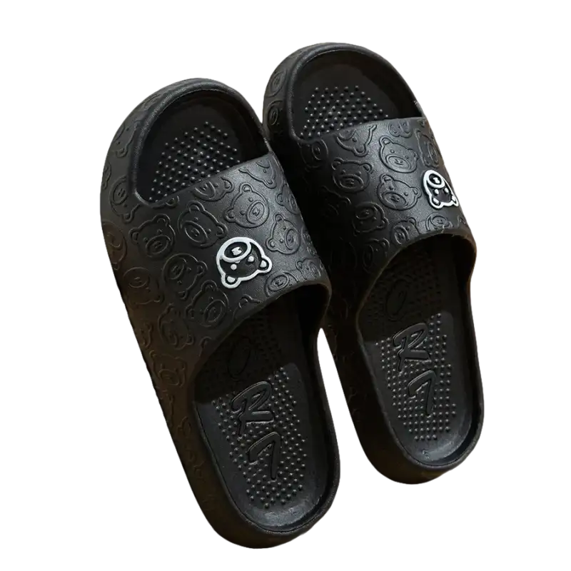 Black cartoon-patterned slide sandals.